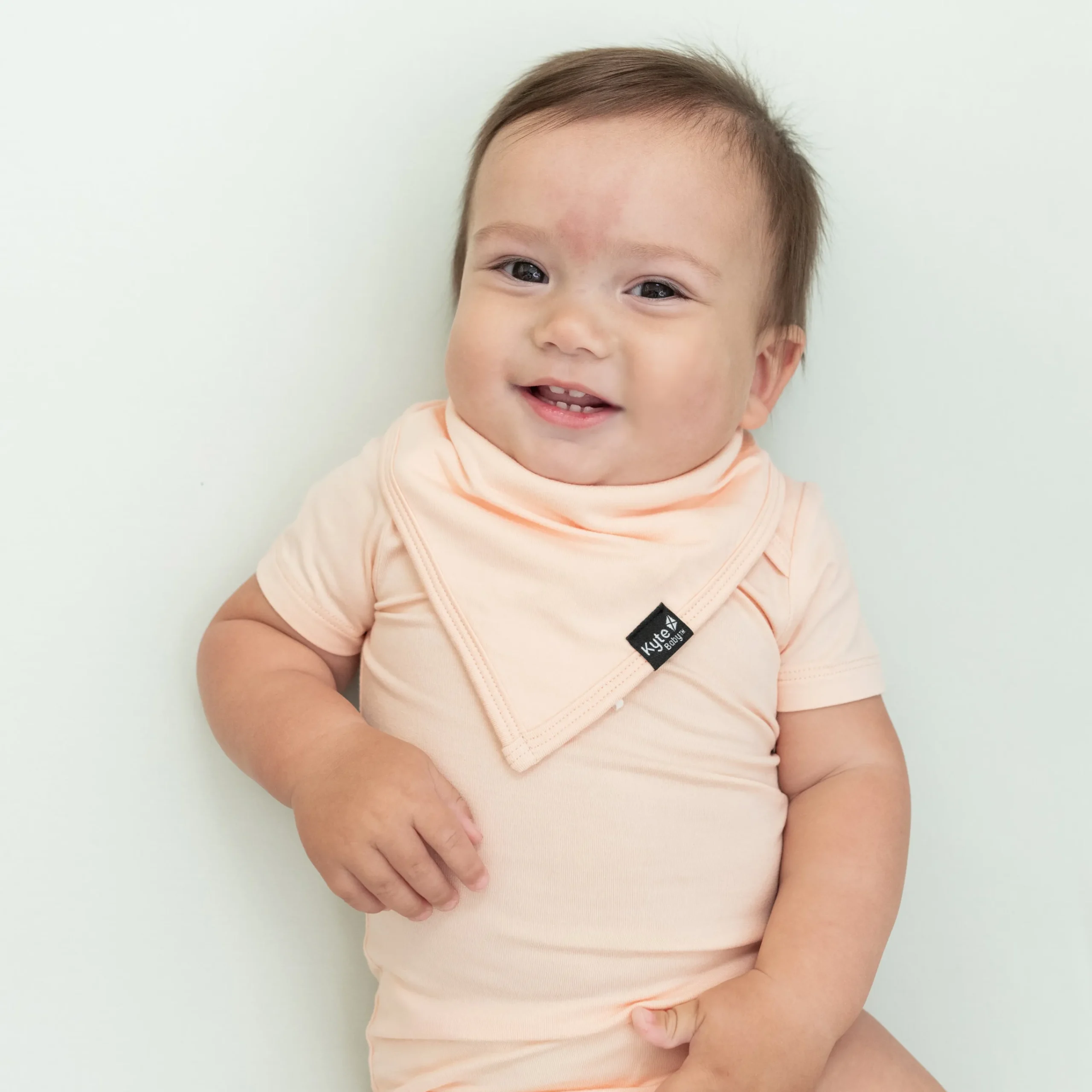 Kyte Baby Bib in Canyon Hot