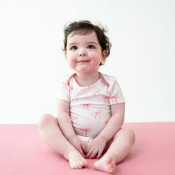 Kyte Baby Bodysuit in Bow Hot
