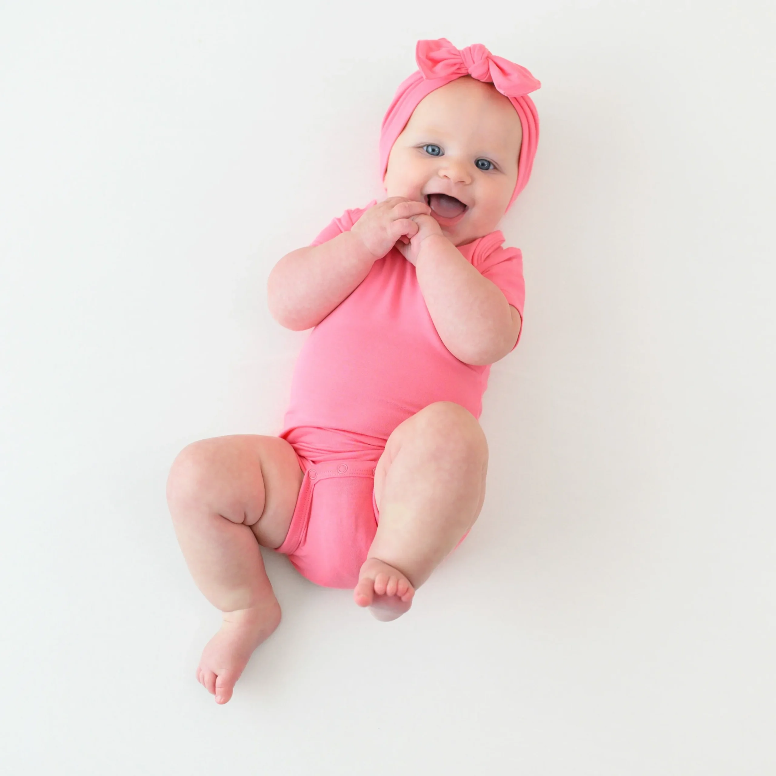 Kyte Baby Bodysuit in Guava New