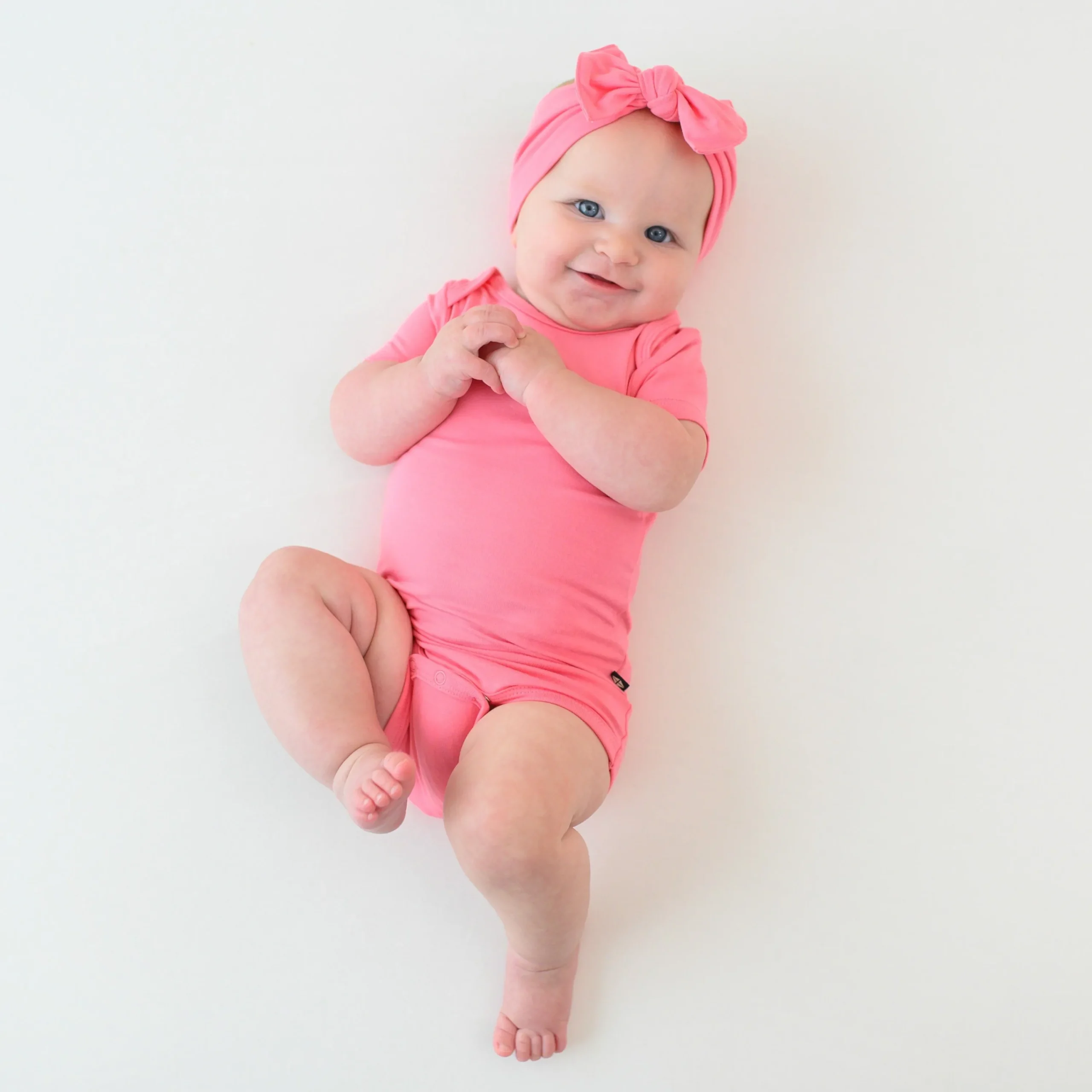 Kyte Baby Bodysuit in Guava New