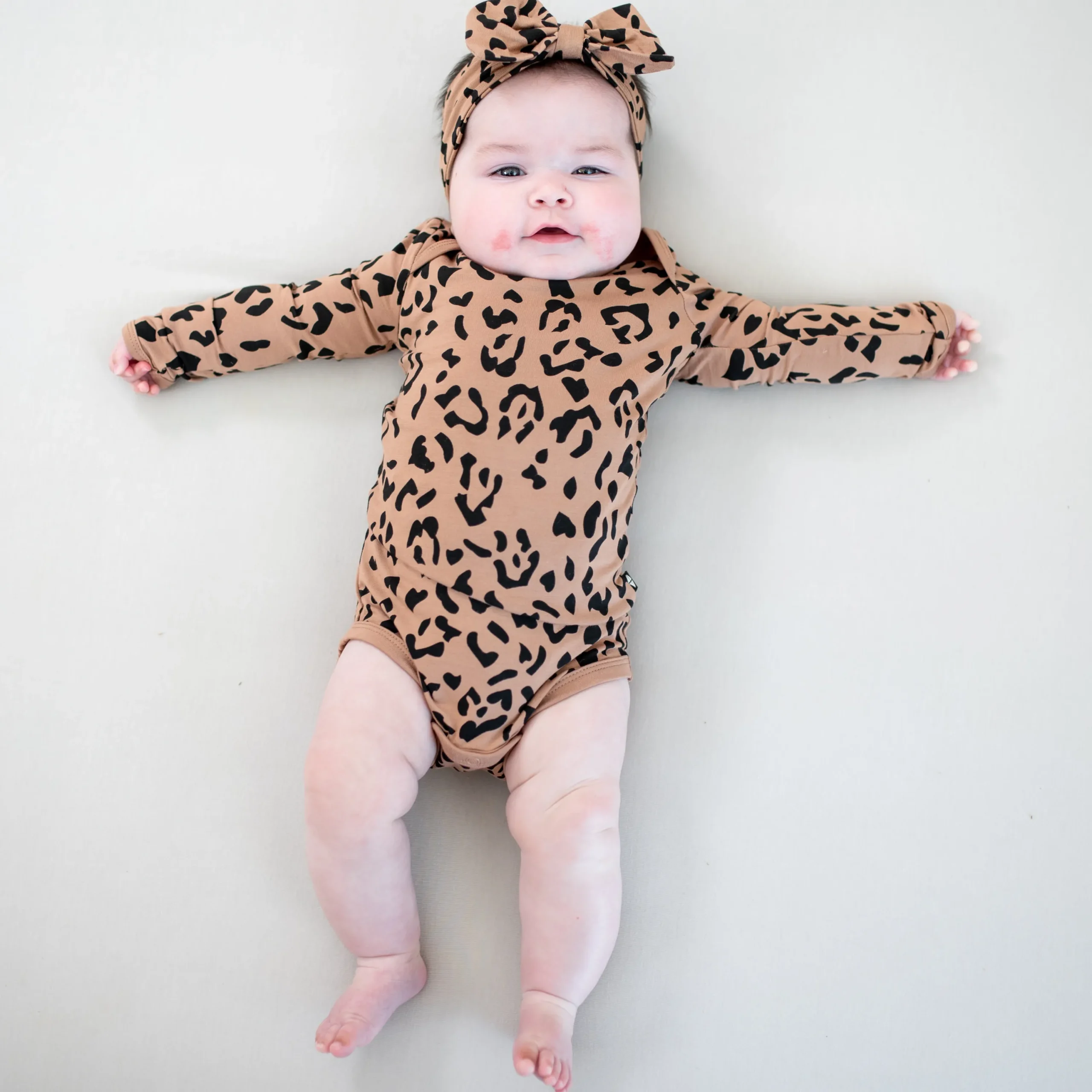 Kyte Baby Long Sleeve Bodysuit in Latte Leopard Best