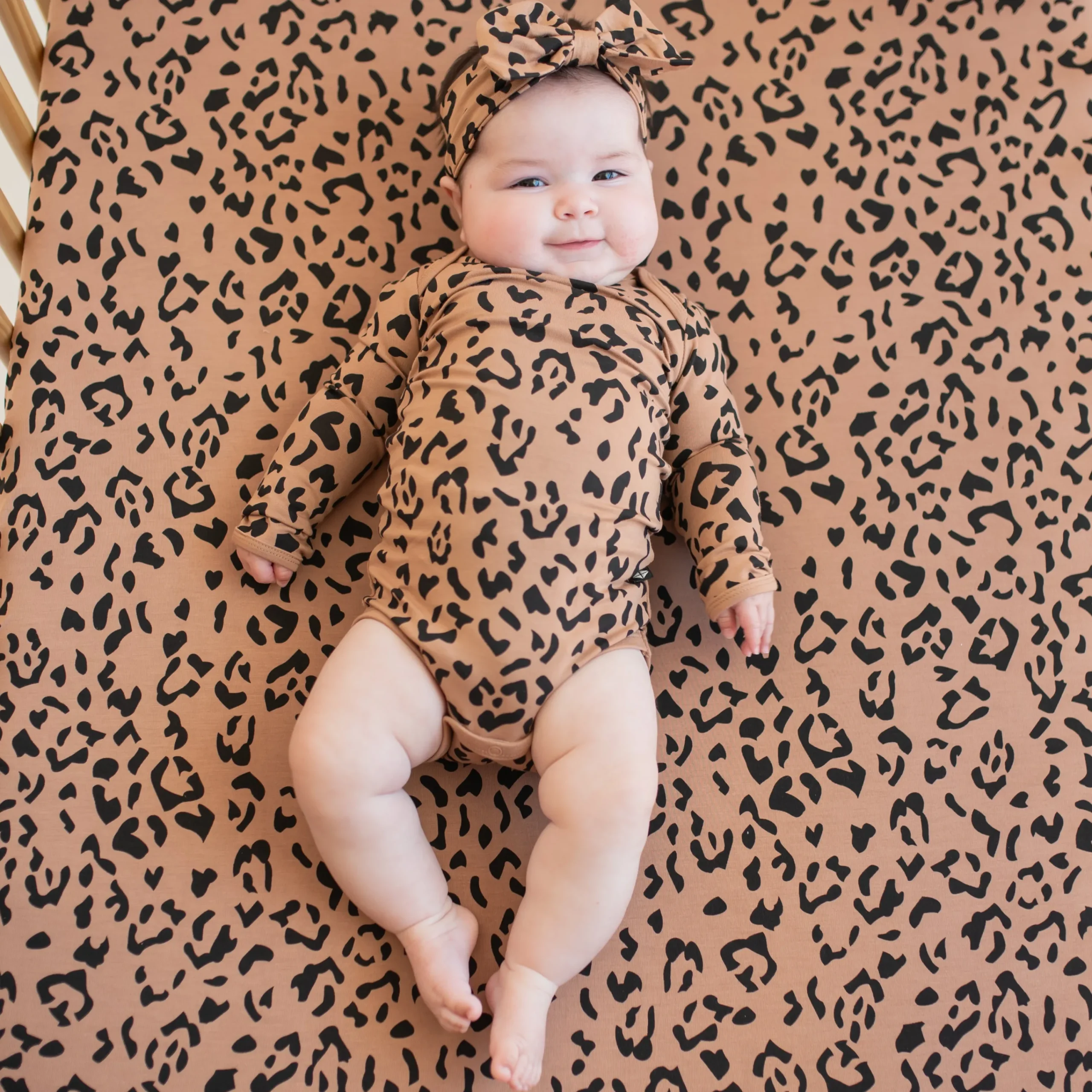 Kyte Baby Long Sleeve Bodysuit in Latte Leopard Best