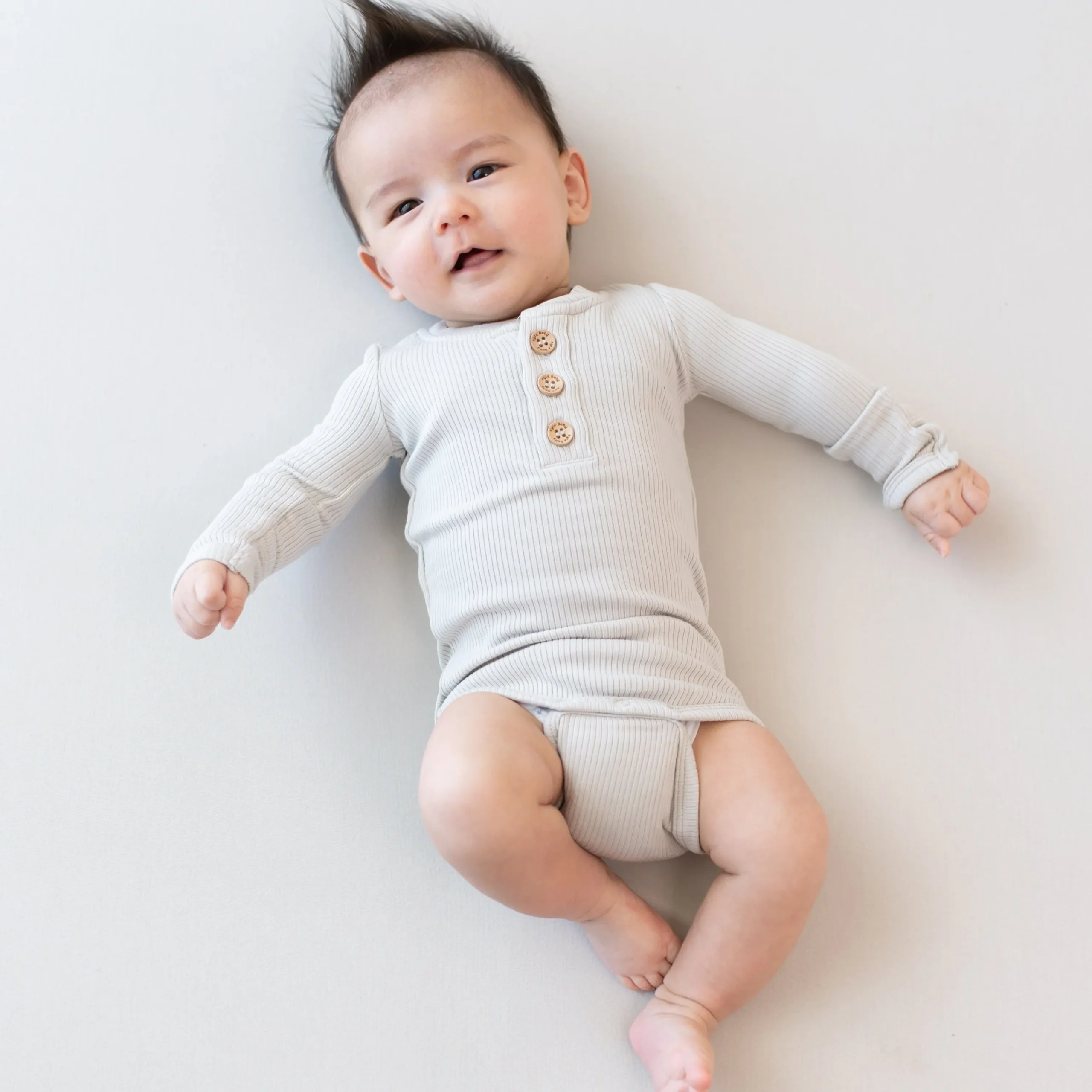 Kyte Baby Ribbed Long Sleeve Henley Bodysuit in Oat Online