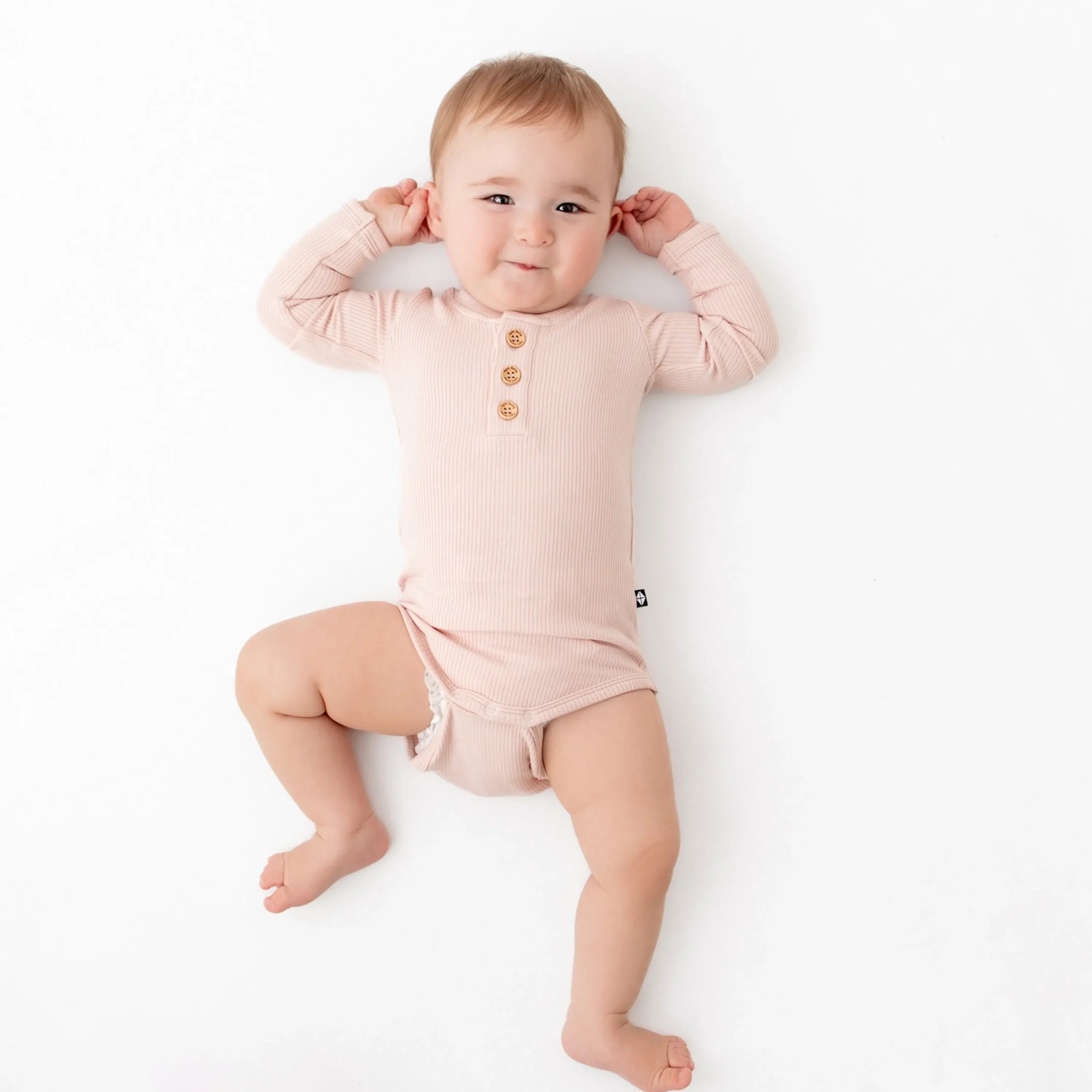 Kyte Baby Ribbed Long Sleeve Henley Bodysuit in Blush Clearance