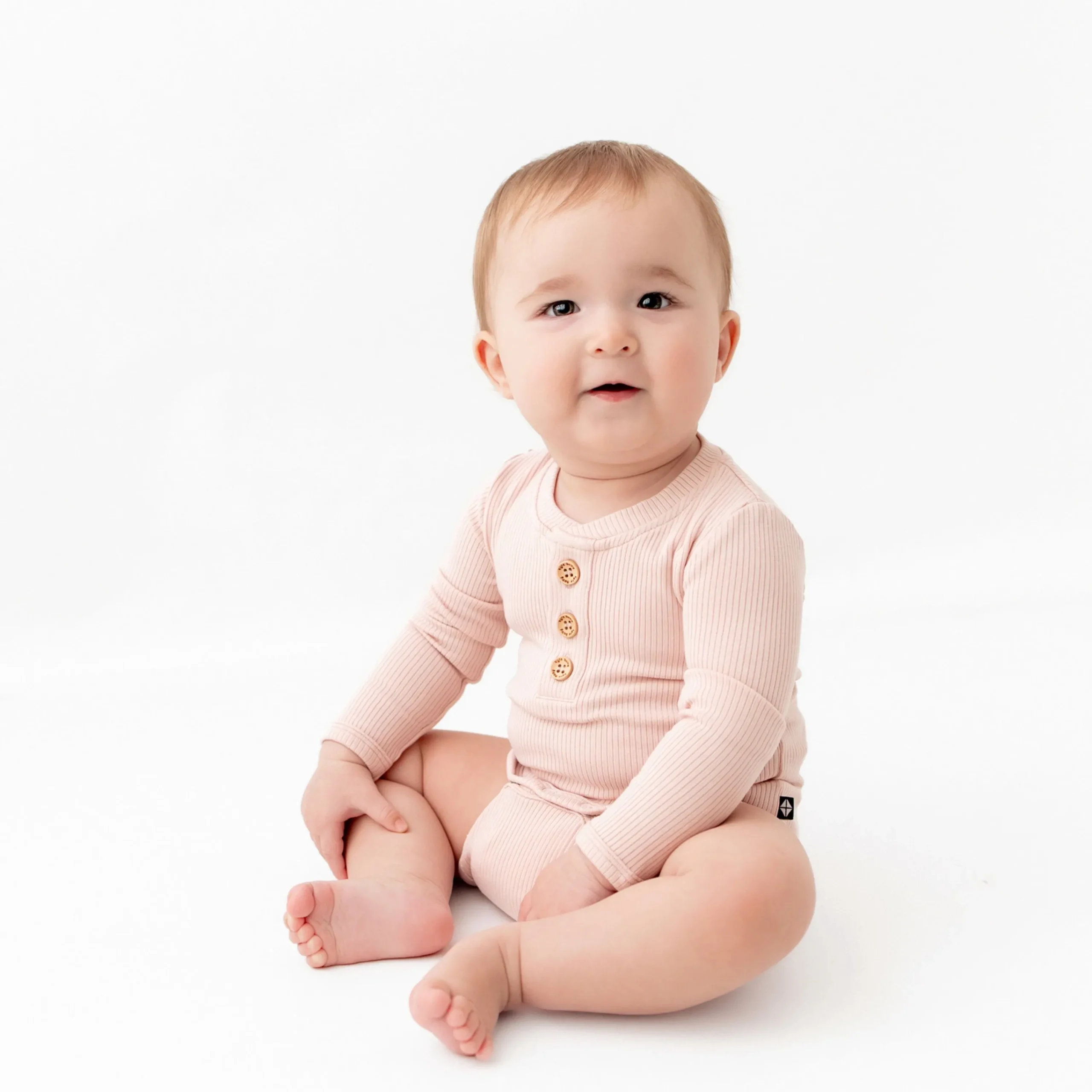 Kyte Baby Ribbed Long Sleeve Henley Bodysuit in Blush Clearance