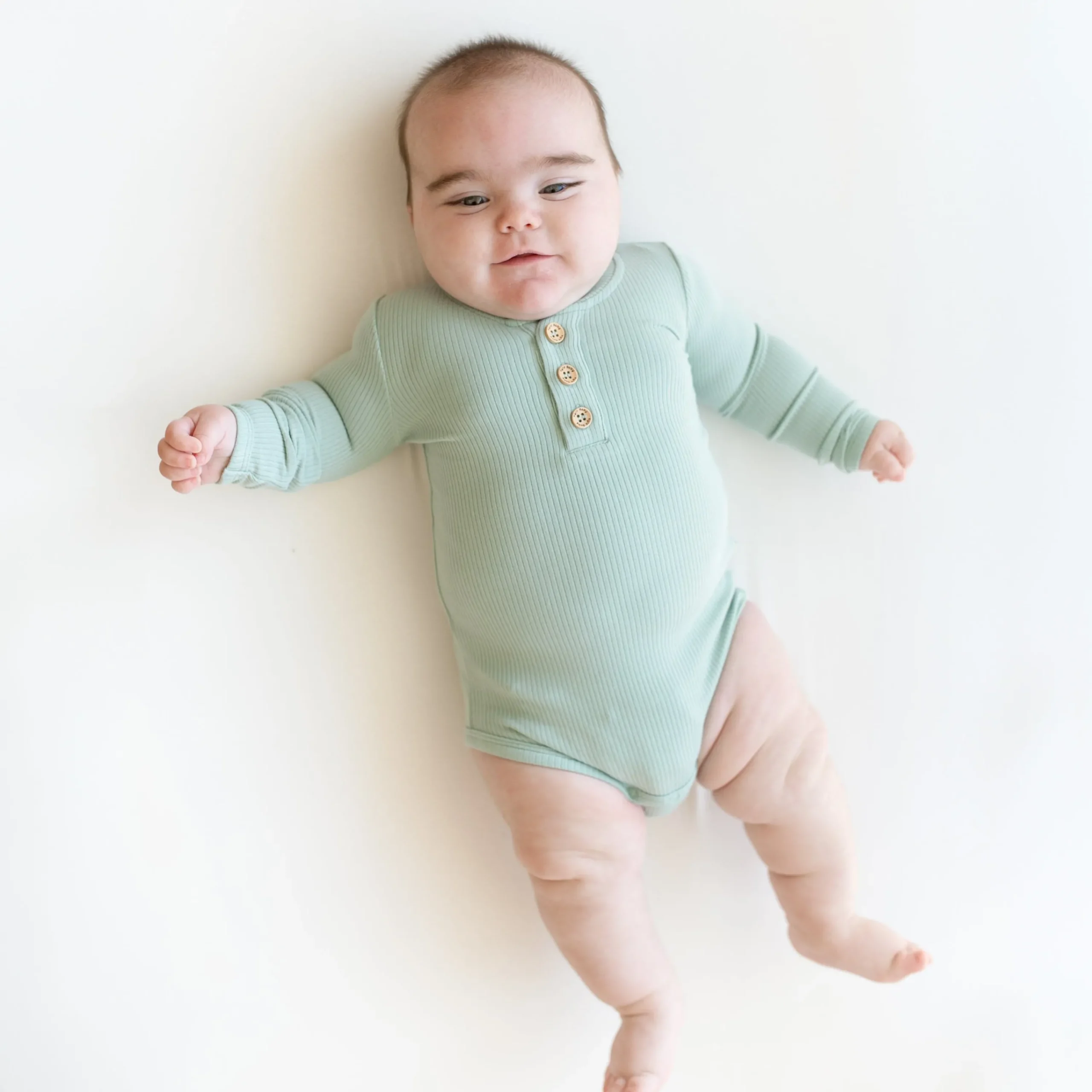 Kyte Baby Ribbed Long Sleeve Henley Bodysuit in Sage Clearance