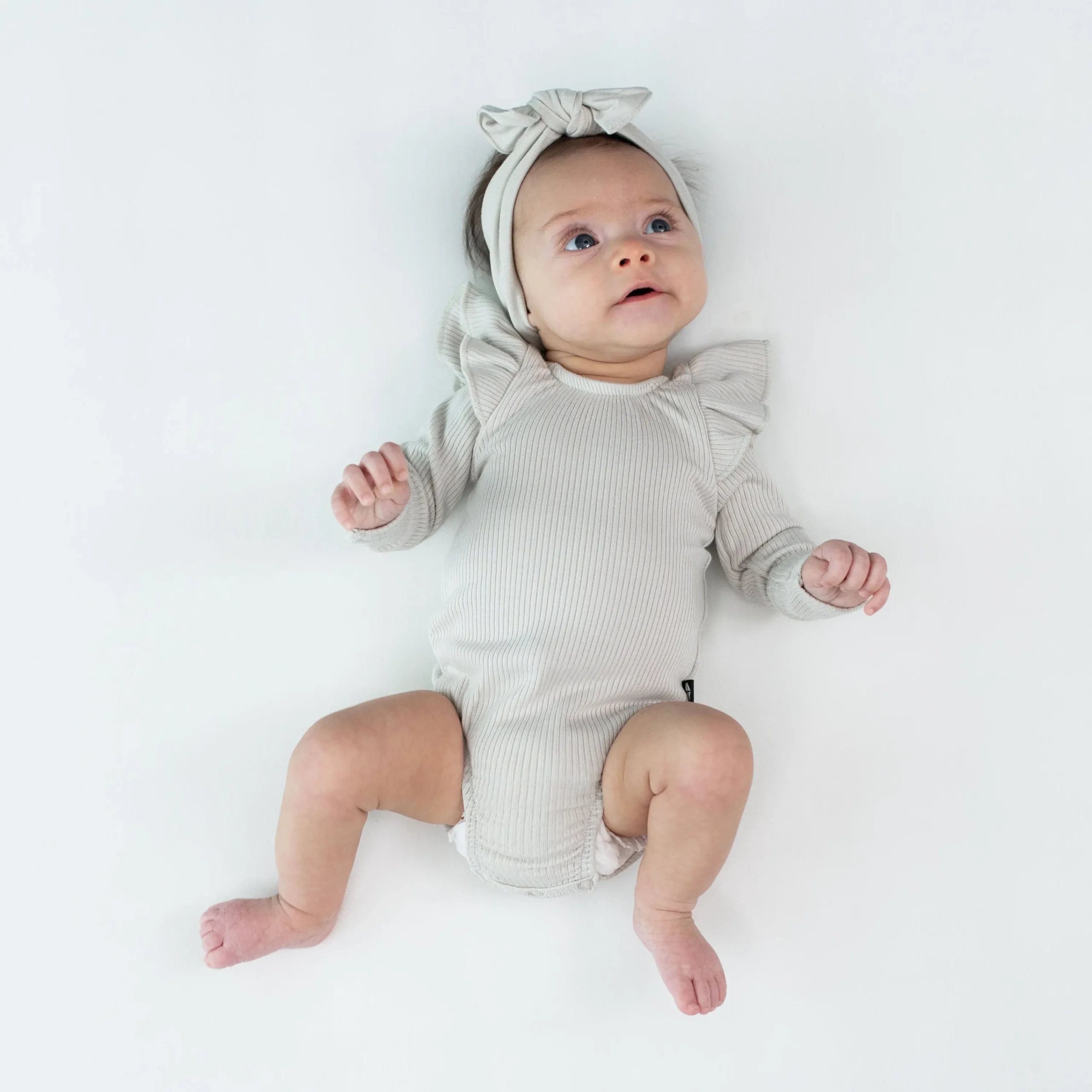 Kyte Baby Ribbed Long Sleeve Ruffle Leotard in Oat