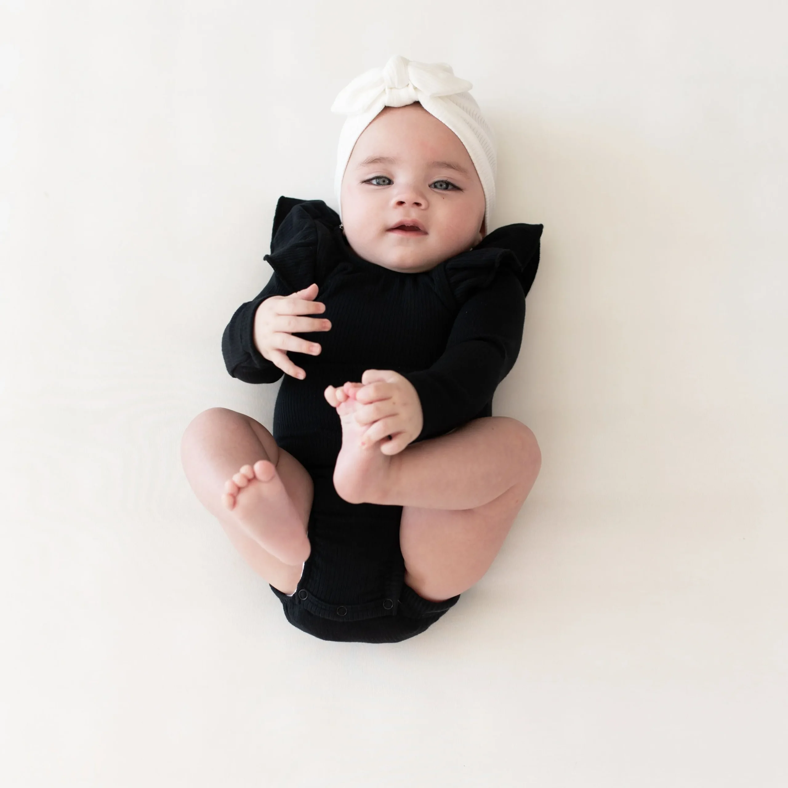 Kyte Baby Ribbed Long Sleeve Ruffle Leotard in Midnight Best