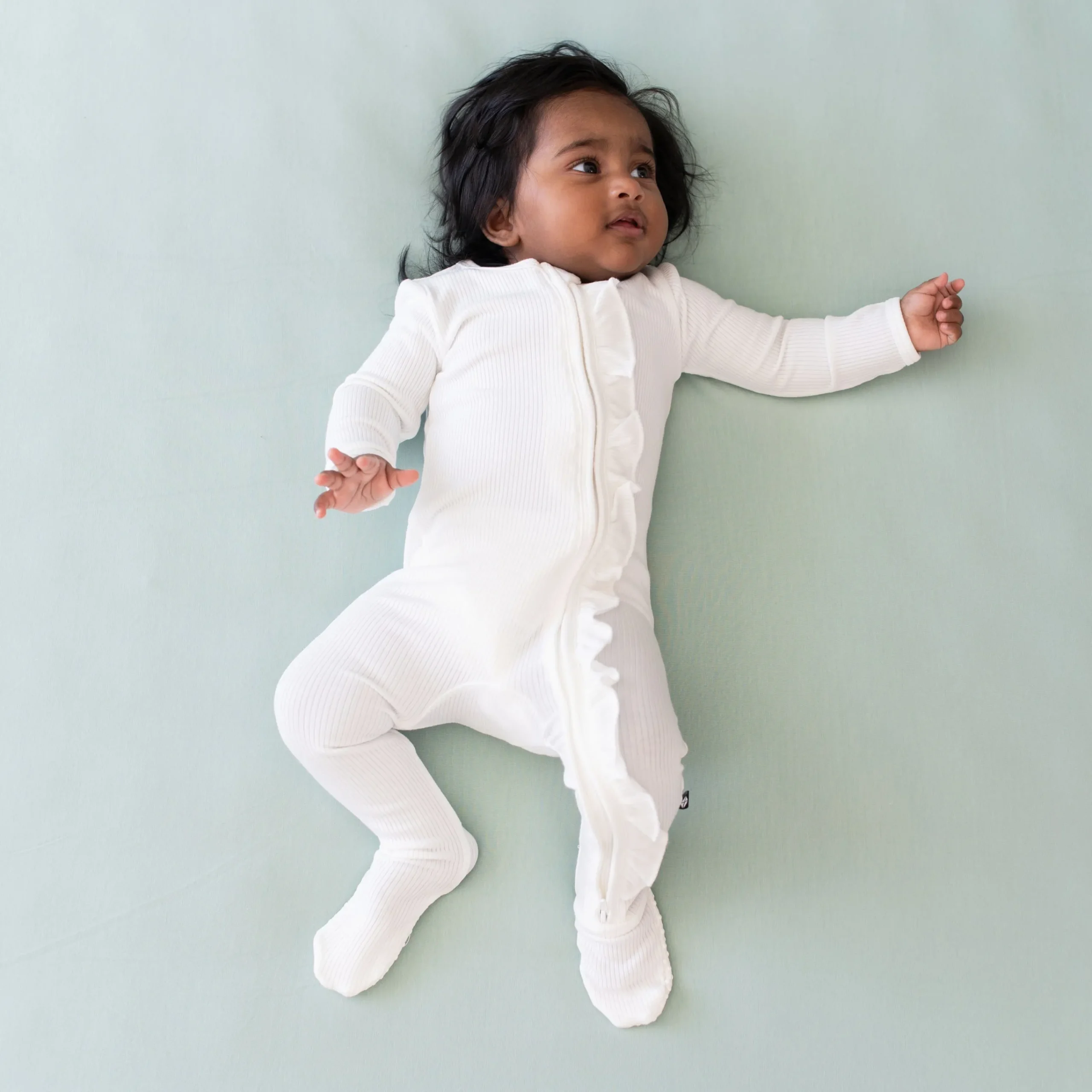 Kyte Baby Ribbed Ruffle Zipper Footie in Cloud