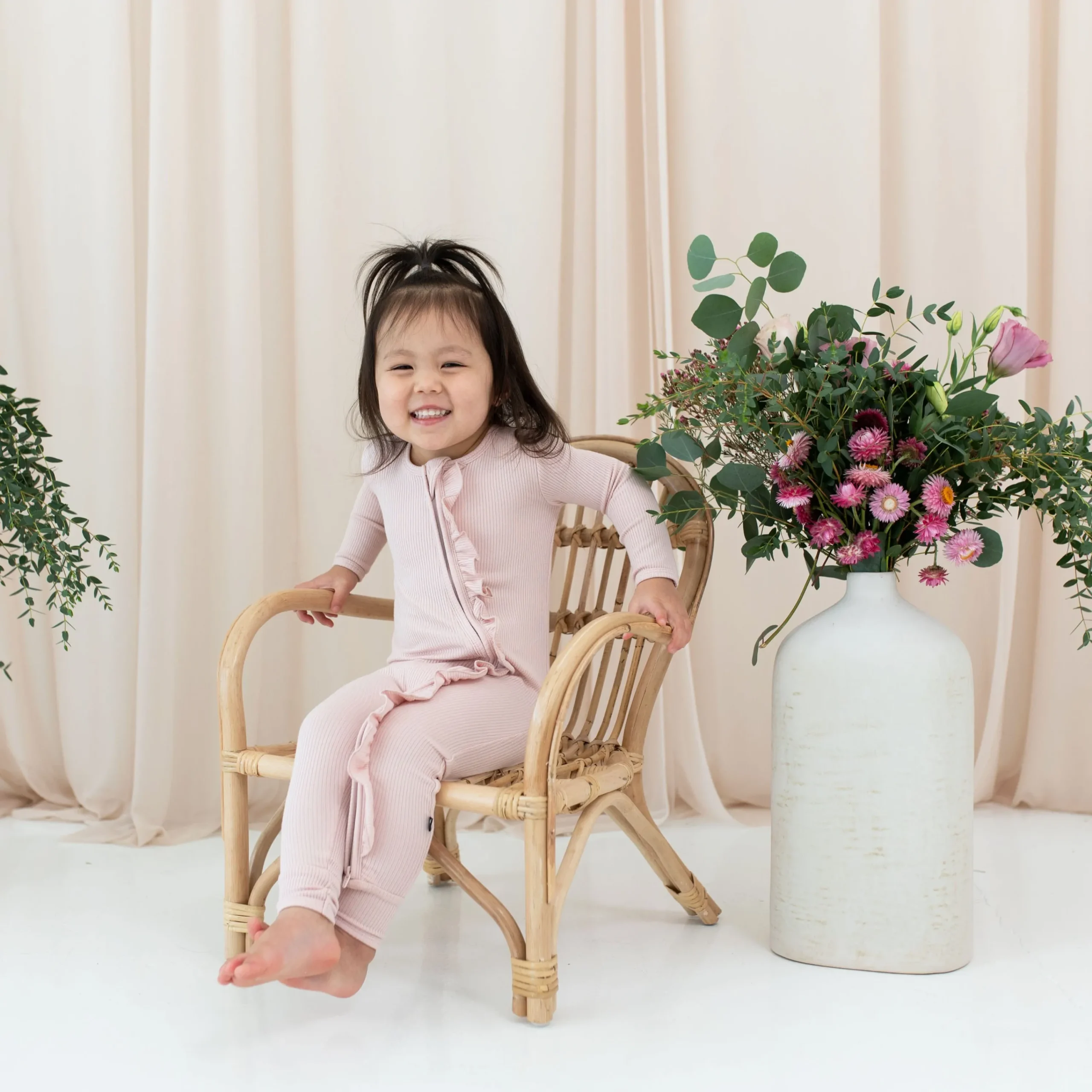 Kyte Baby Ribbed Ruffle Zipper Romper in Blush Hot