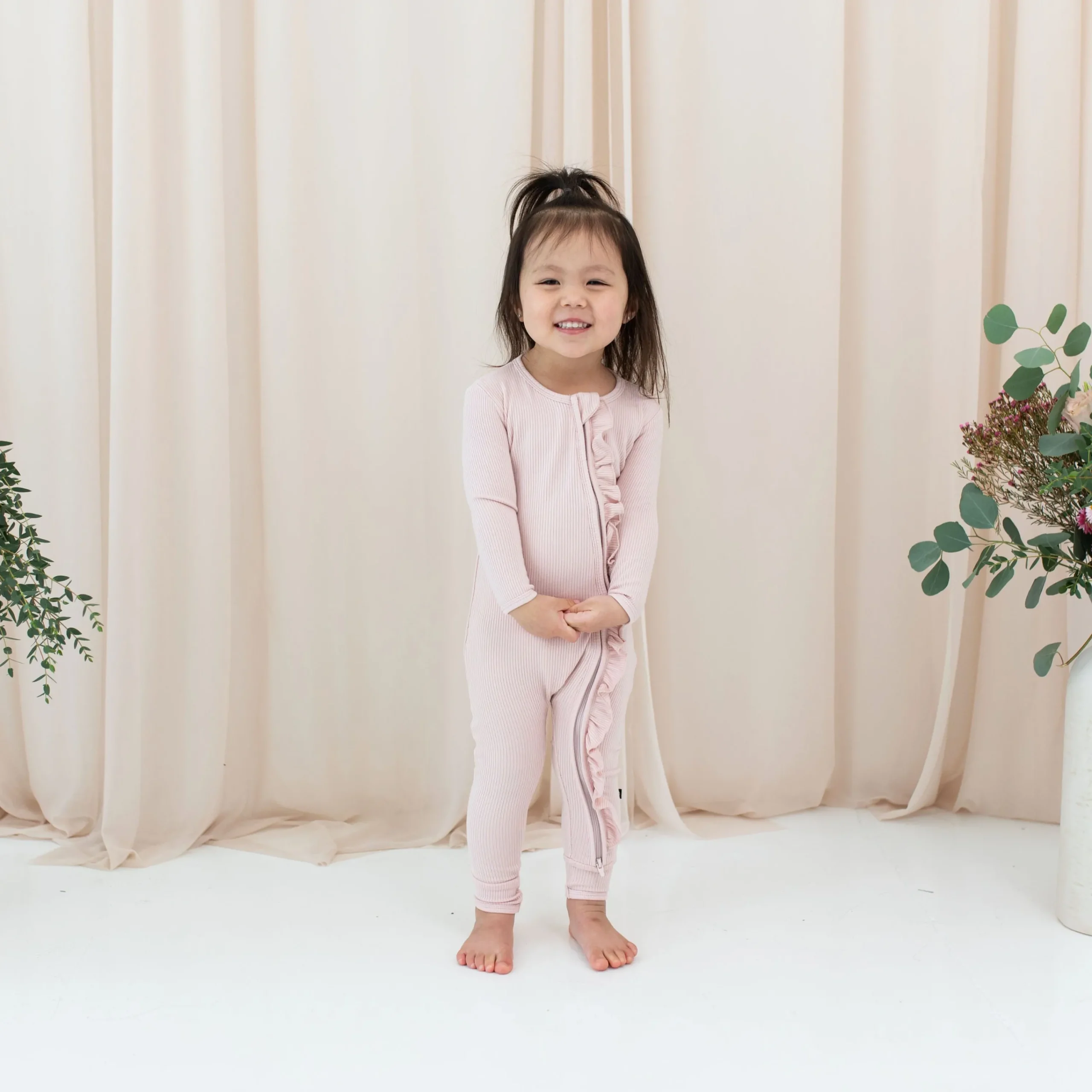 Kyte Baby Ribbed Ruffle Zipper Romper in Blush Hot