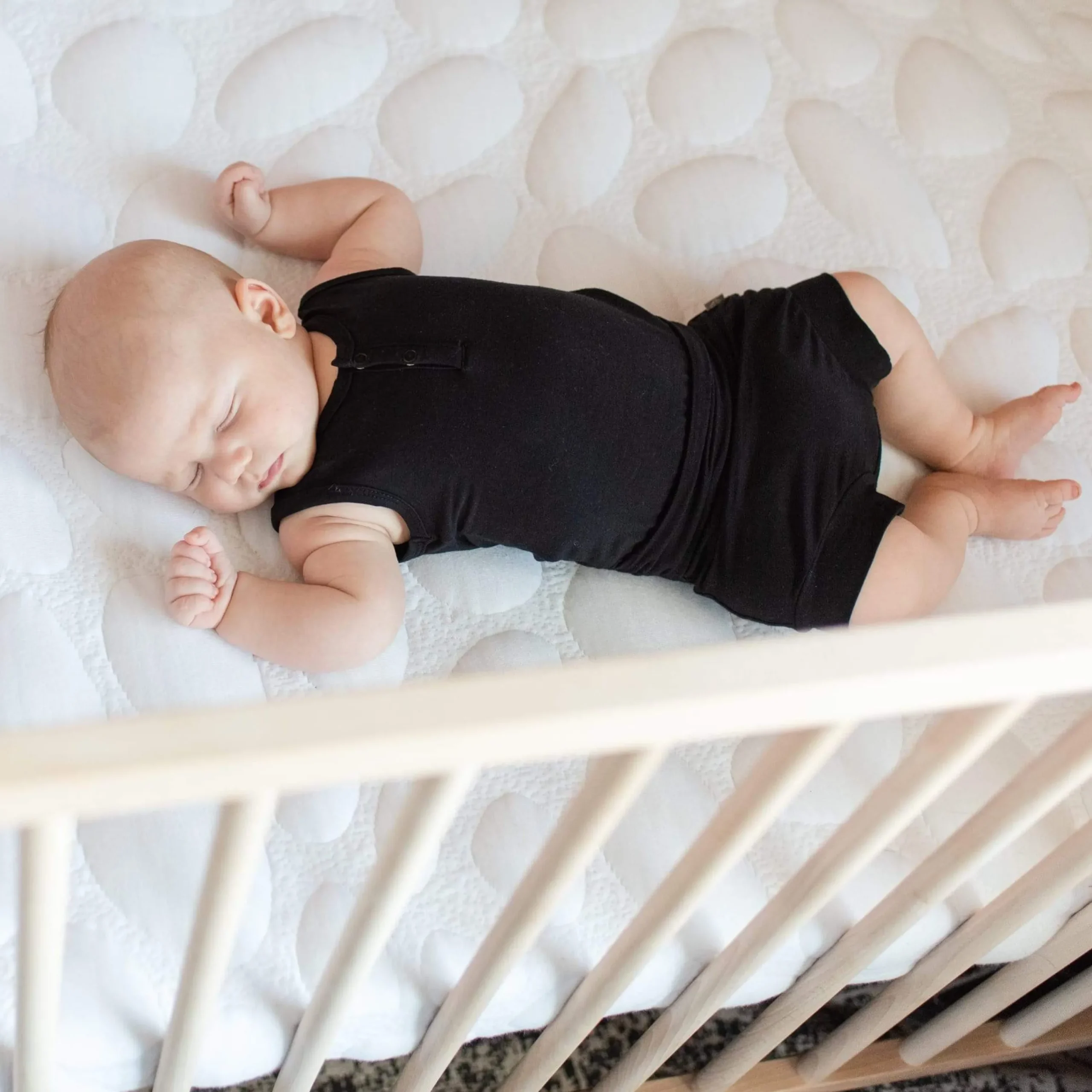 Kyte Baby Sleeveless Bodysuit in Midnight Hot