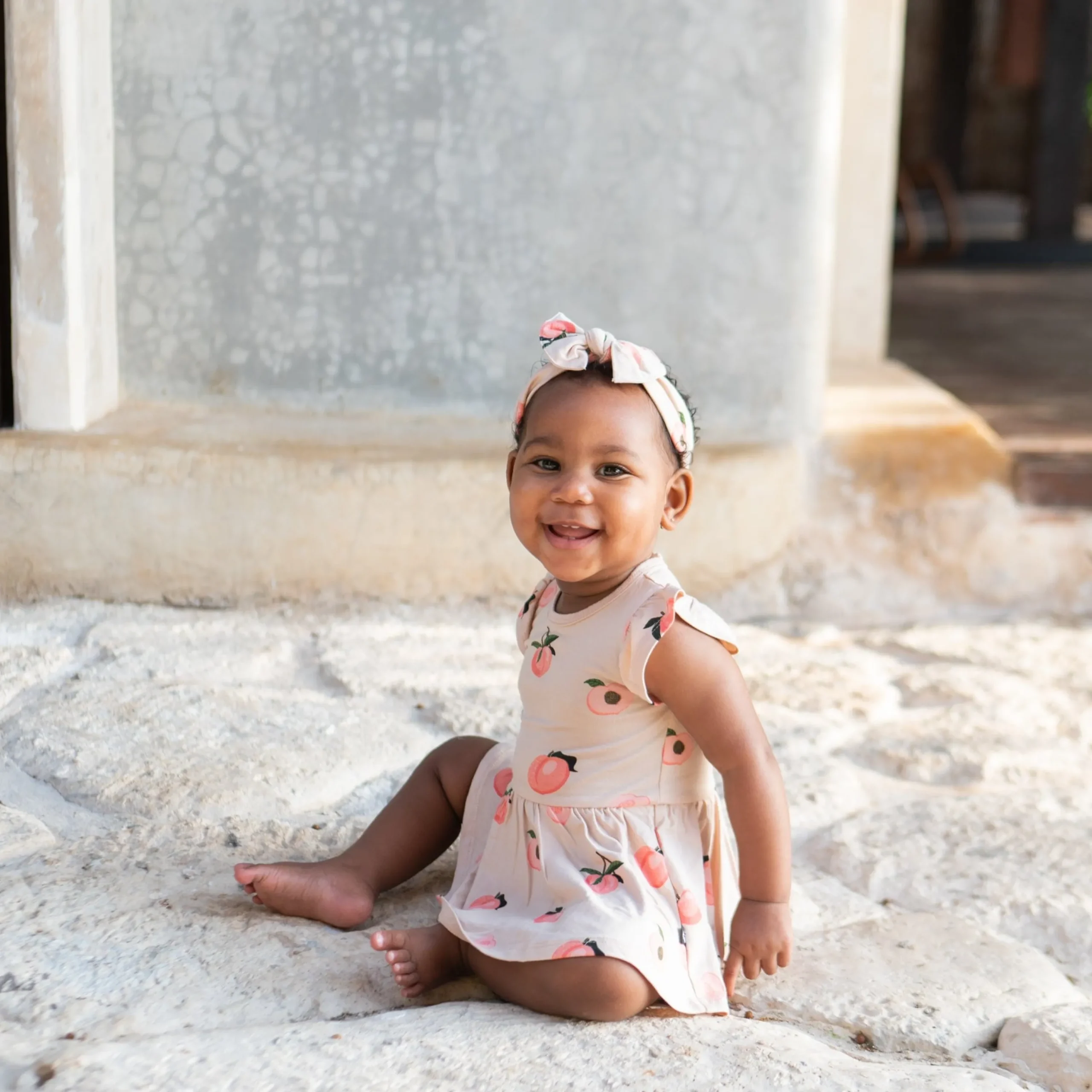Kyte Baby Twirl Bodysuit Dress in Peach