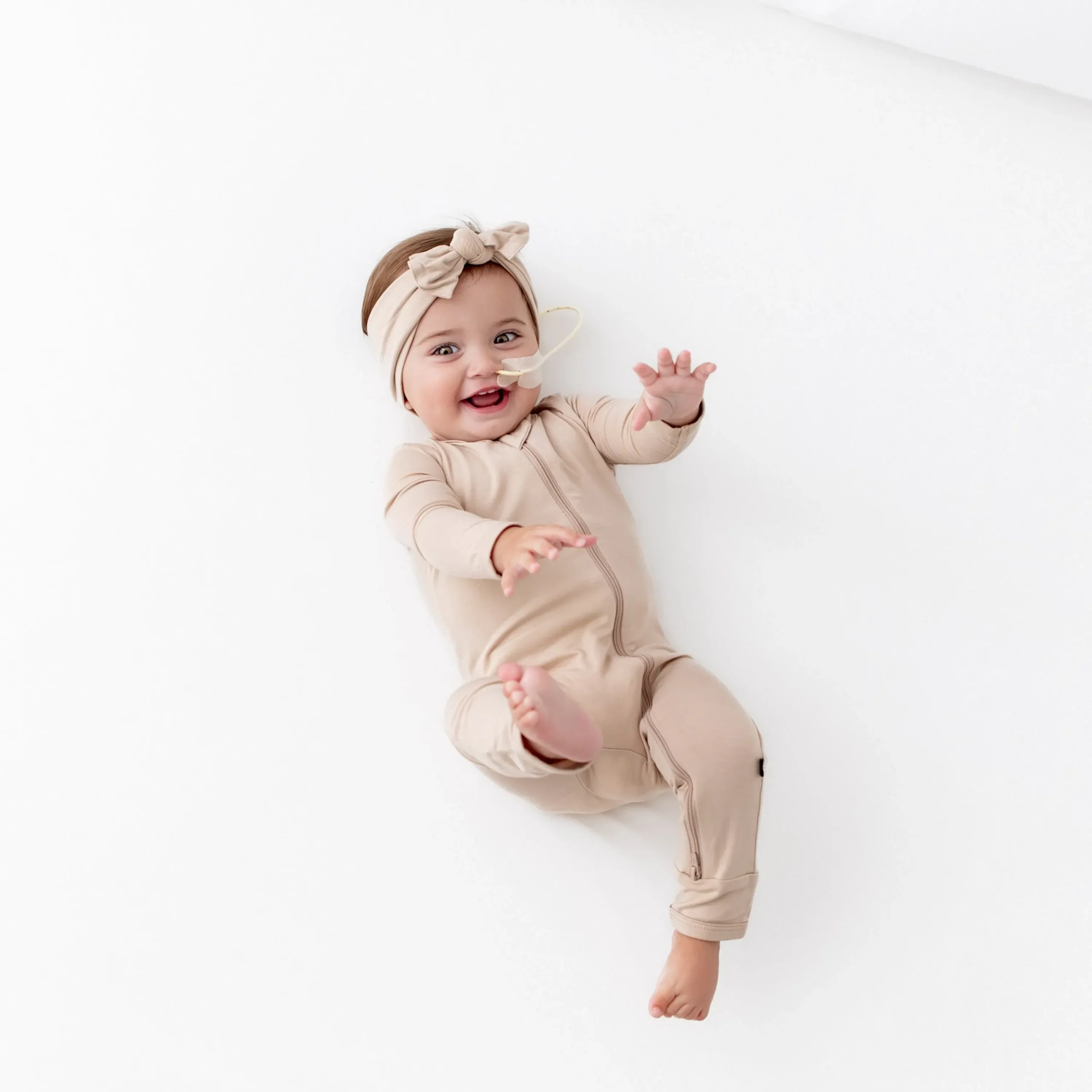 Kyte Baby Zippered Romper in Bisque Hot