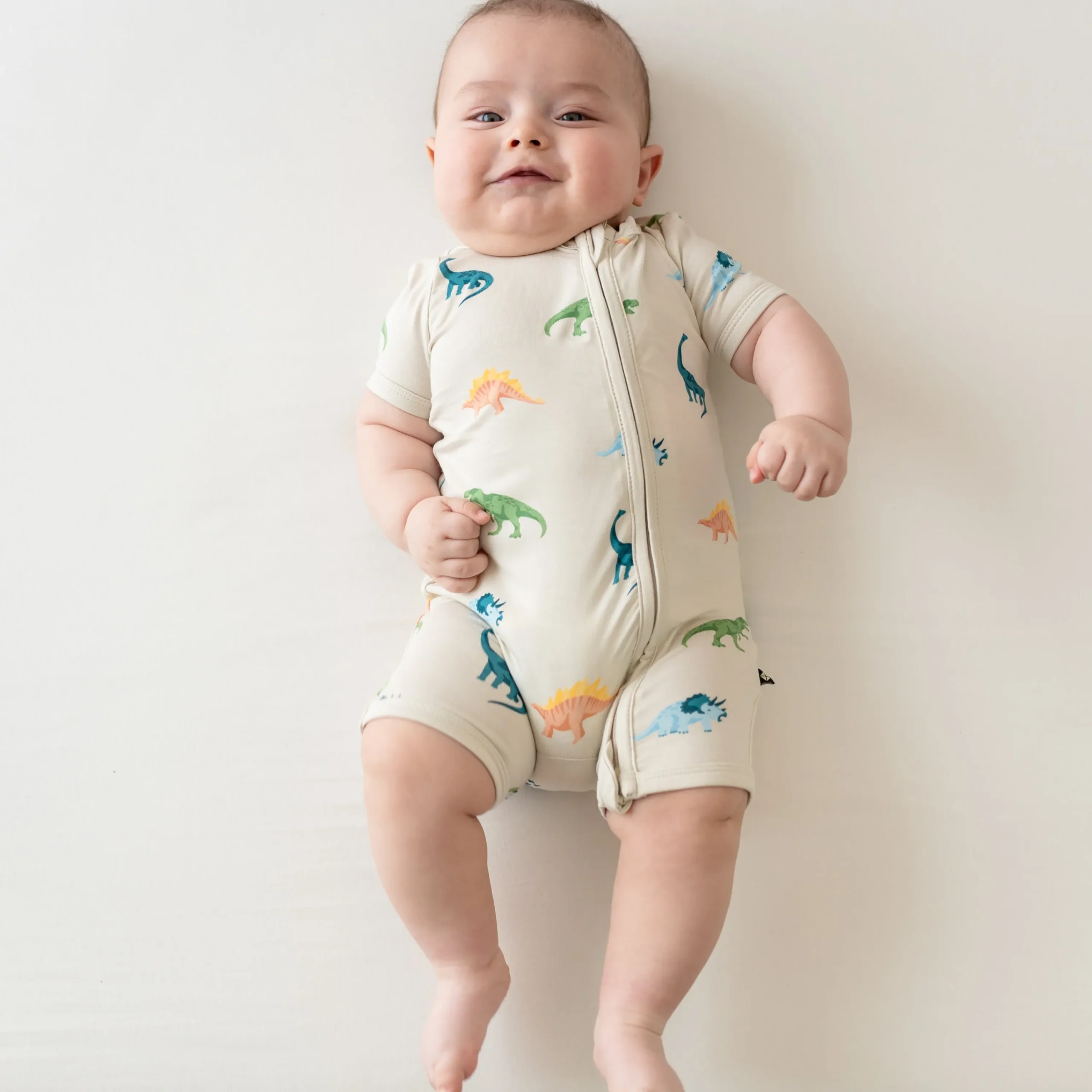 Kyte Baby Zippered Shortall Romper in Ecru Roar Best